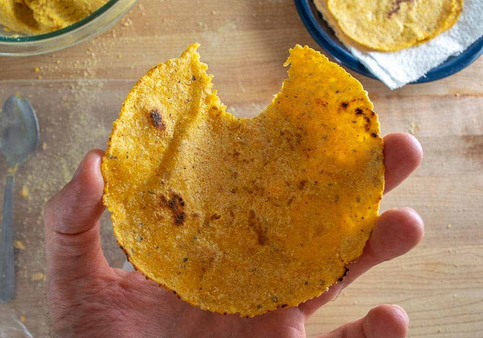 Taking a bite of corn tortilla after cooking
