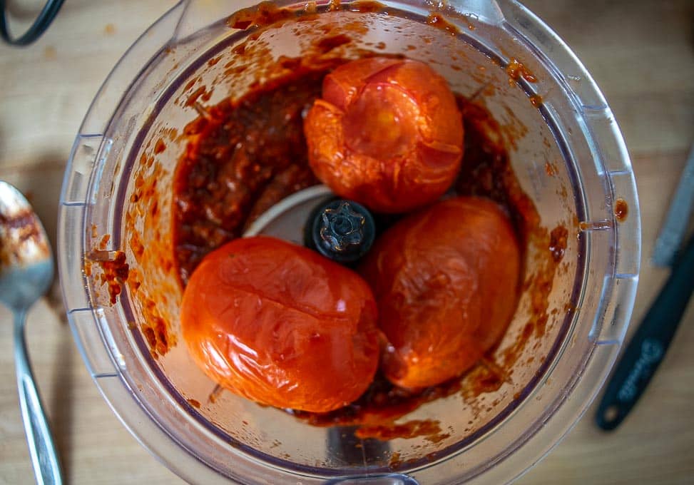 Adding roasted tomatoes to the blender