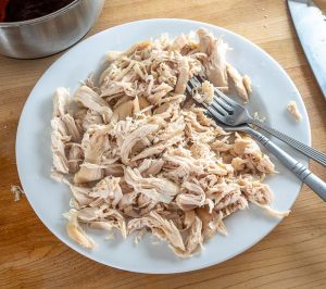 Single pound of chicken after being shredded with two forks