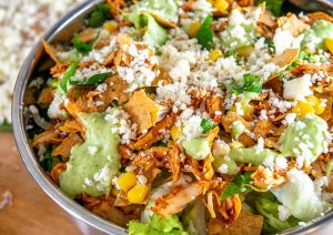 Here are two great options for some home-cooked Mexican Chicken Salads! The first is a traditional Chicken Taco Salad, and the second relies on some Spicy Cabbage Slaw.