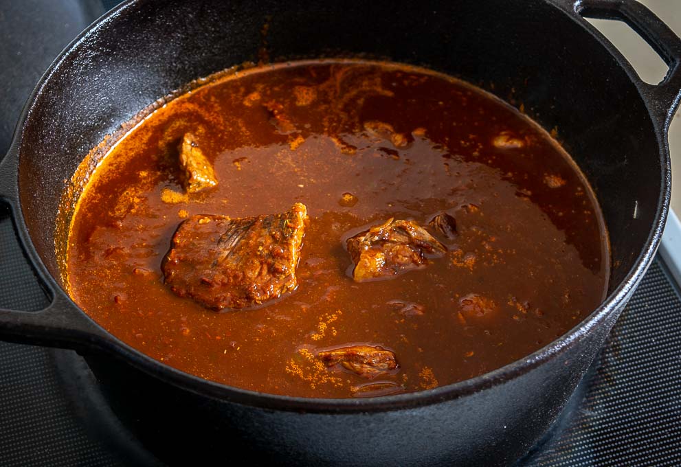 Chili after adding seared beef pieces and roasted tomatoes