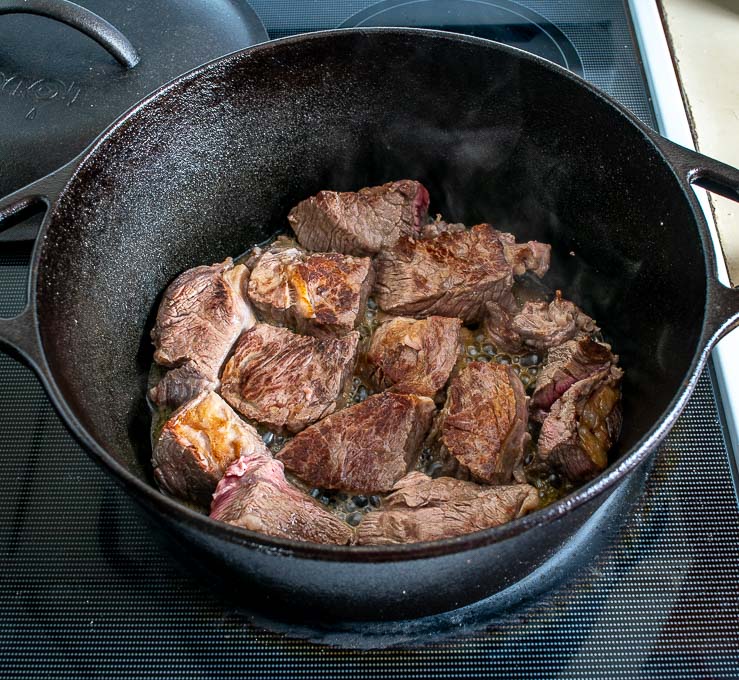 Searing beef pieces in Lodge cast iron Dutch oven