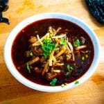 Red Pozole with crispy tortilla strips and freshly chopped cilantro