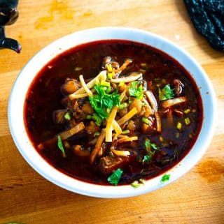 Red Pozole with crispy tortilla strips and freshly chopped cilantro