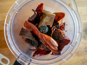 Adding dried chiles to the blender
