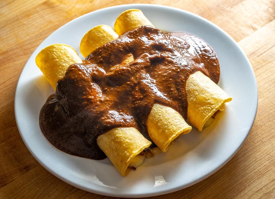 Strained Mole Poblano sauce over corn tortillas