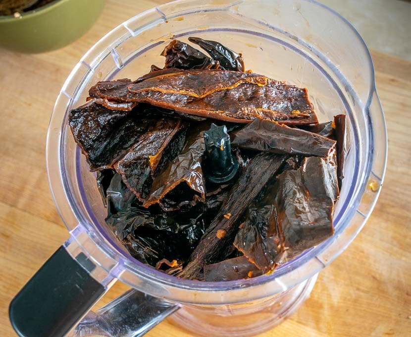 Adding reconstituted dried chiles to the blender