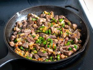 Adding beef and bacon back to the pan