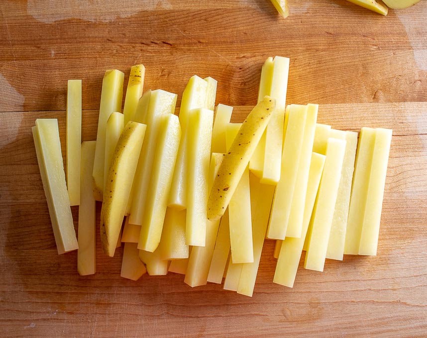 Chopping up potatoes into fries