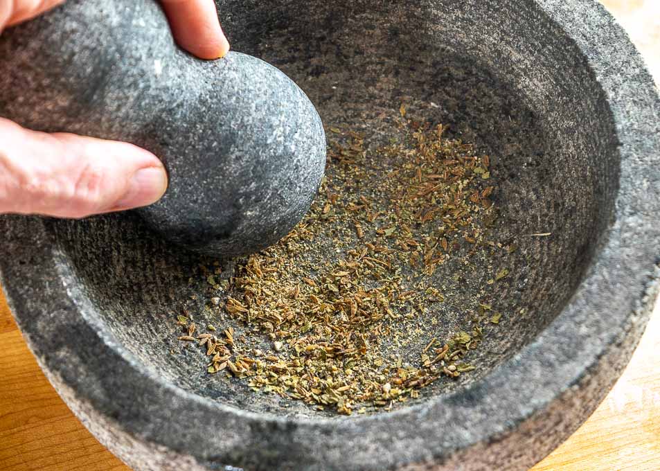 Crushing the spices in a molcajete