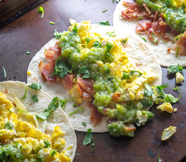 Breakfast Tacos with eggs, bacon, Salsa Verde, and cilantro