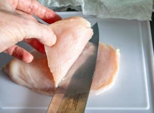 Slicing chicken breast in half lengthwise