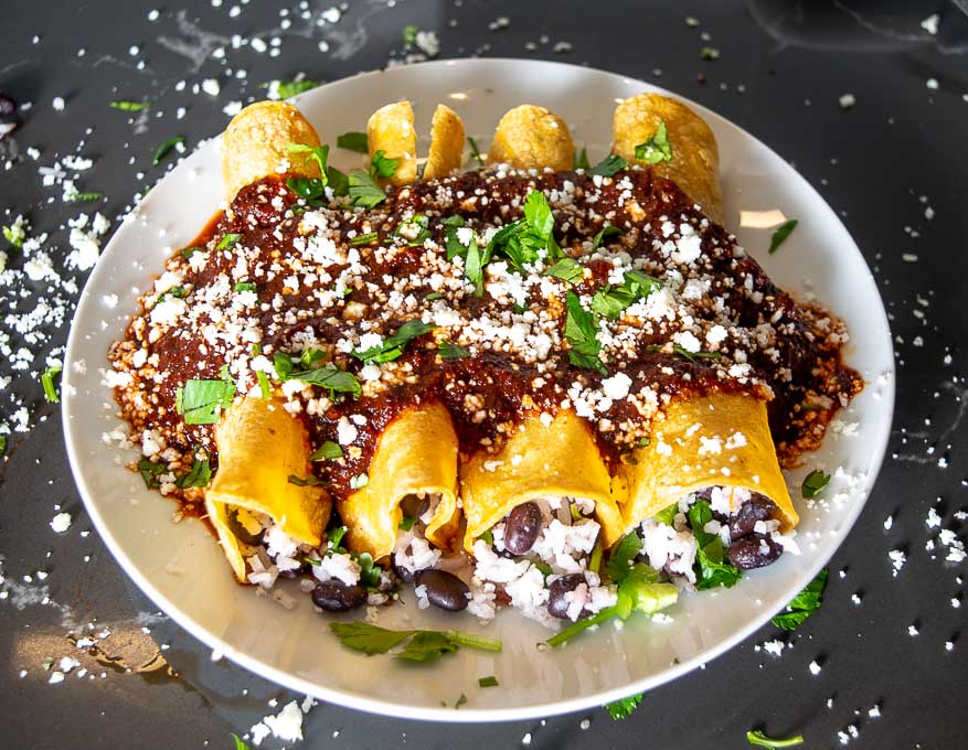 plate full of black bean enchiladas