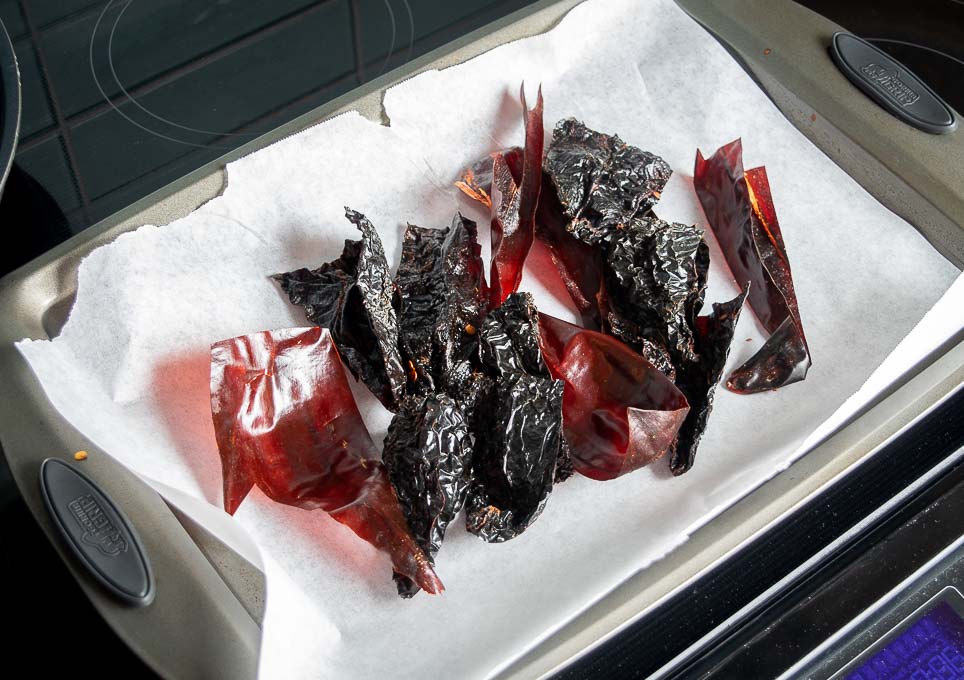 Roasting dried chile pieces in the oven for 1-2 minutes