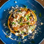 Adding cilantro and lime to each tostada