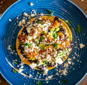 Adding cilantro and lime to each tostada