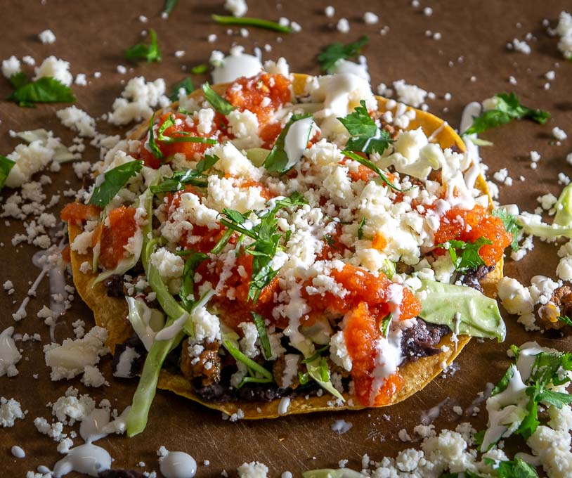 Adding Crema and Queso Fresco to the tostadas