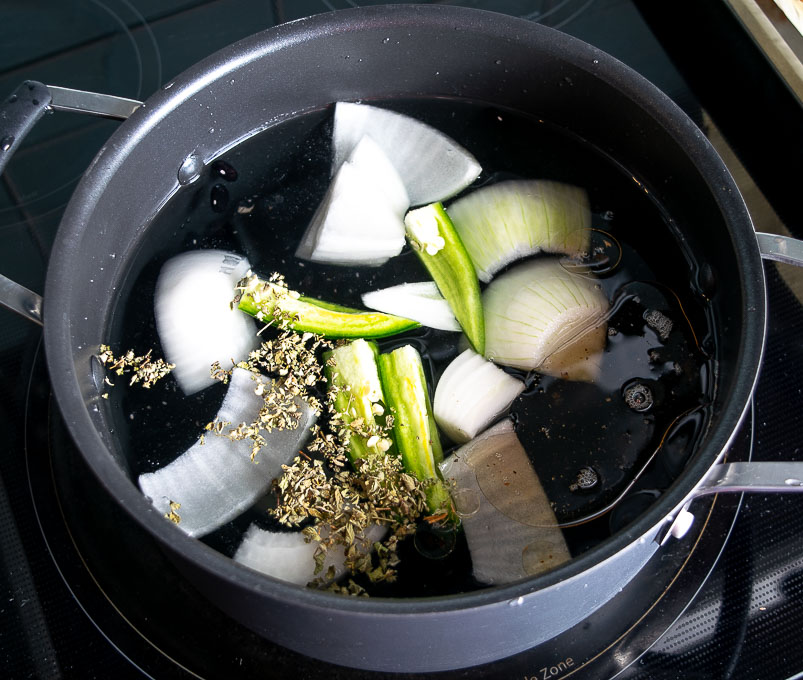 Bean pot full of onion, jalapeno, and Mexican oregano