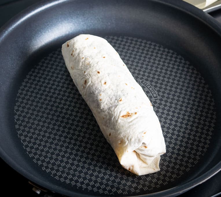 Crisping up the burrito in a dry skillet over medium heat