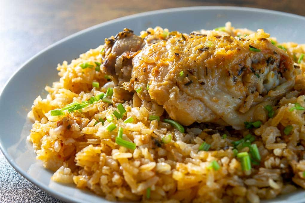 Topping the Arroz con Pollo with freshly chopped cilantro stems