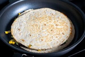 Light brown spots forming on the flour tortilla in skillet