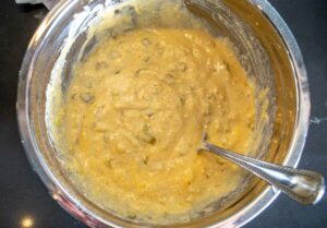 Adding chopped Hatch chiles to the cornbread batter