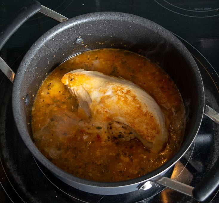 Adding chicken to the saucepan