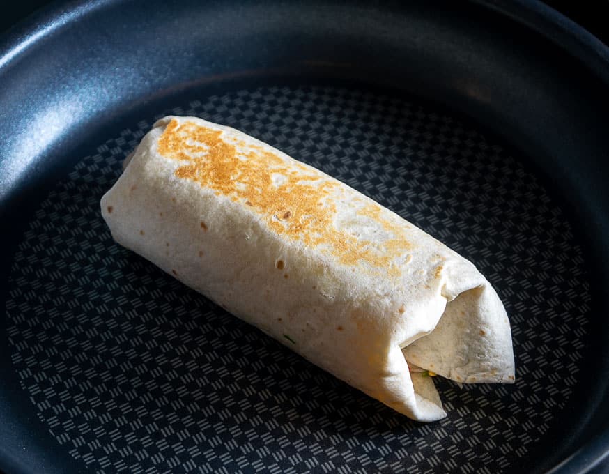 Crisping up the burrito in a dry skillet over medium heat