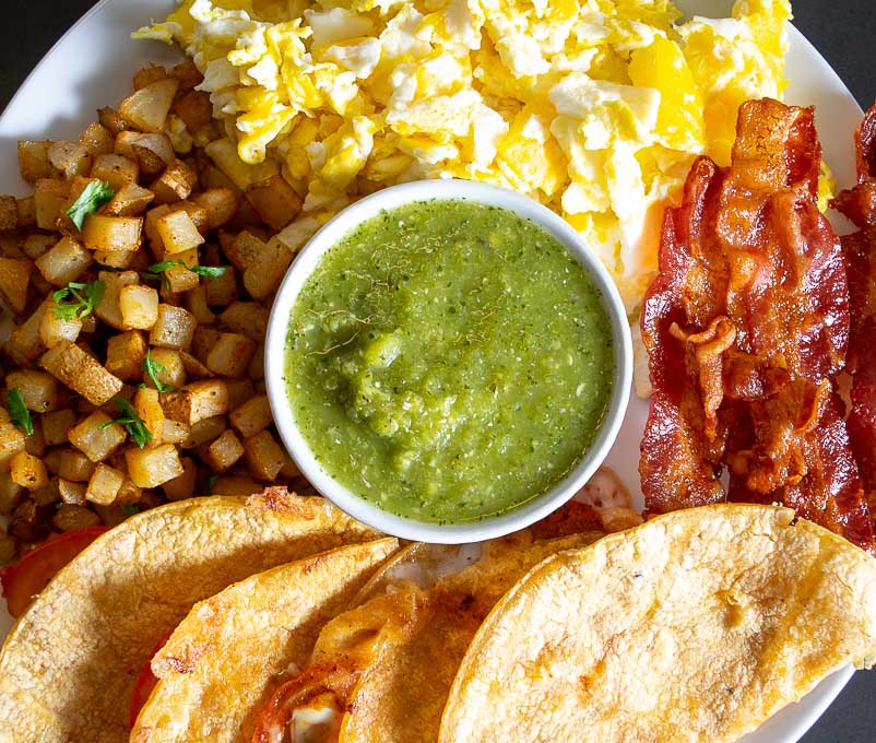 Eggs, bacon, potatoes, corn tortillas, and Jalapeno Sauce