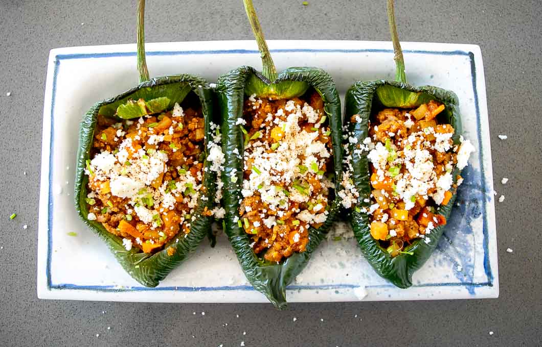 What a treat to put these Picadillo Stuffed Poblano Peppers on the kitchen table in front of friends and family! They are easy to make and have a unique, satisfying flavor. 