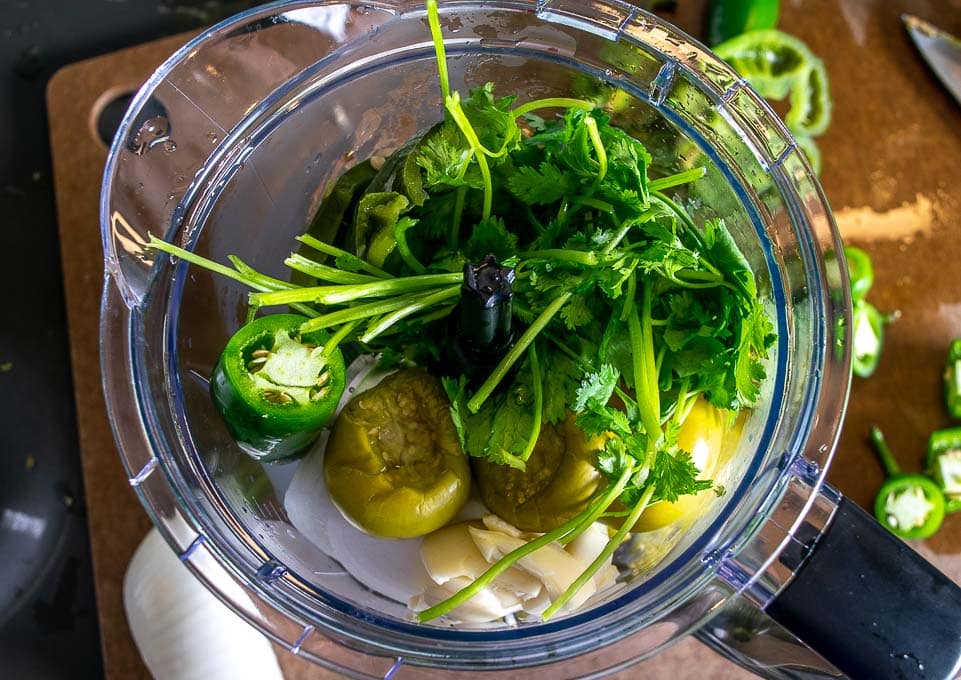 Adding the Chile Verde ingredients to a blender