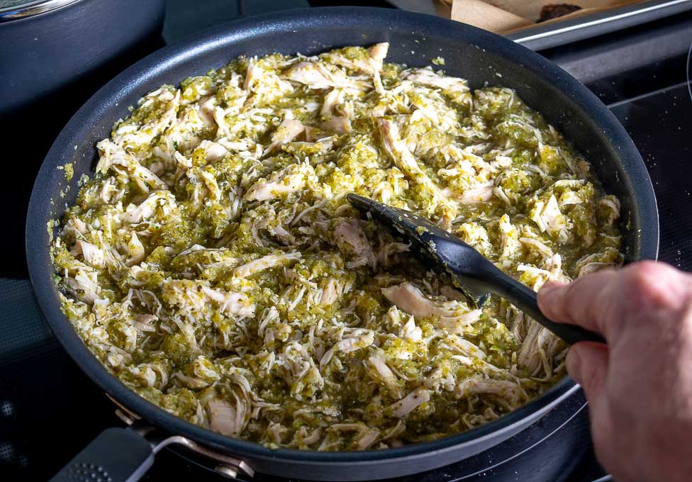 Adding the shredded, cooked chicken to the Chile Verde sauce