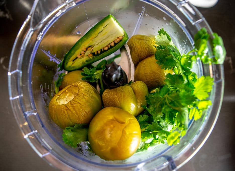 Adding Salsa Verde ingredients to the blender