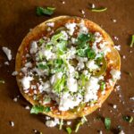 Adding Queso Fresco to the Charro Bean Tostadas