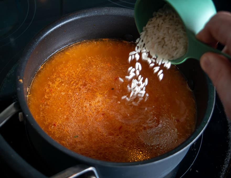 Adding white rice to the soup