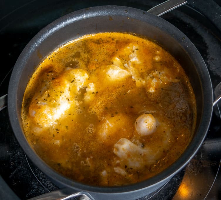 Adding eggs to the simmering Salsa