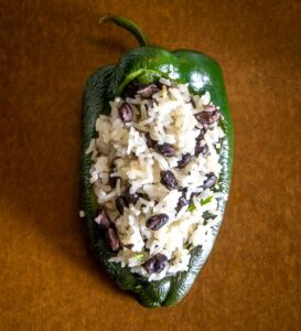Adding beans and rice to the roasted Poblano
