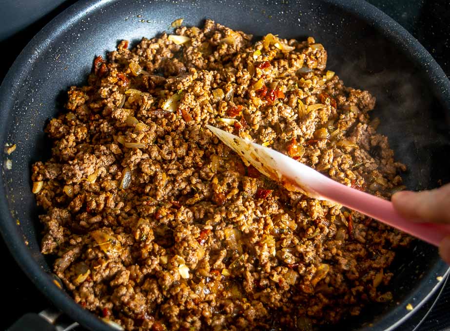 Adding the remaining ingredients to the ground beef