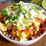 Adding the Salsa Verde, Queso Fresco, and freshly chopped cilantro to the breakfast burrito bowls