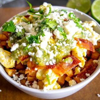 Adding the Salsa Verde, Queso Fresco, and freshly chopped cilantro to the breakfast burrito bowls