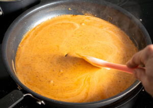 Stirring the creamy chipotle sauce