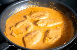 Adding the chicken back to the creamy chipotle sauce