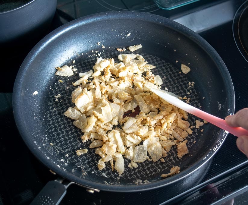 Adding flour to the onion garlic mixture to thicken it up