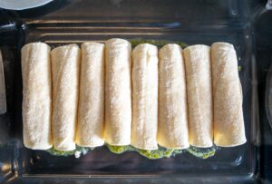 Rolling 8 enchiladas for the baking dish