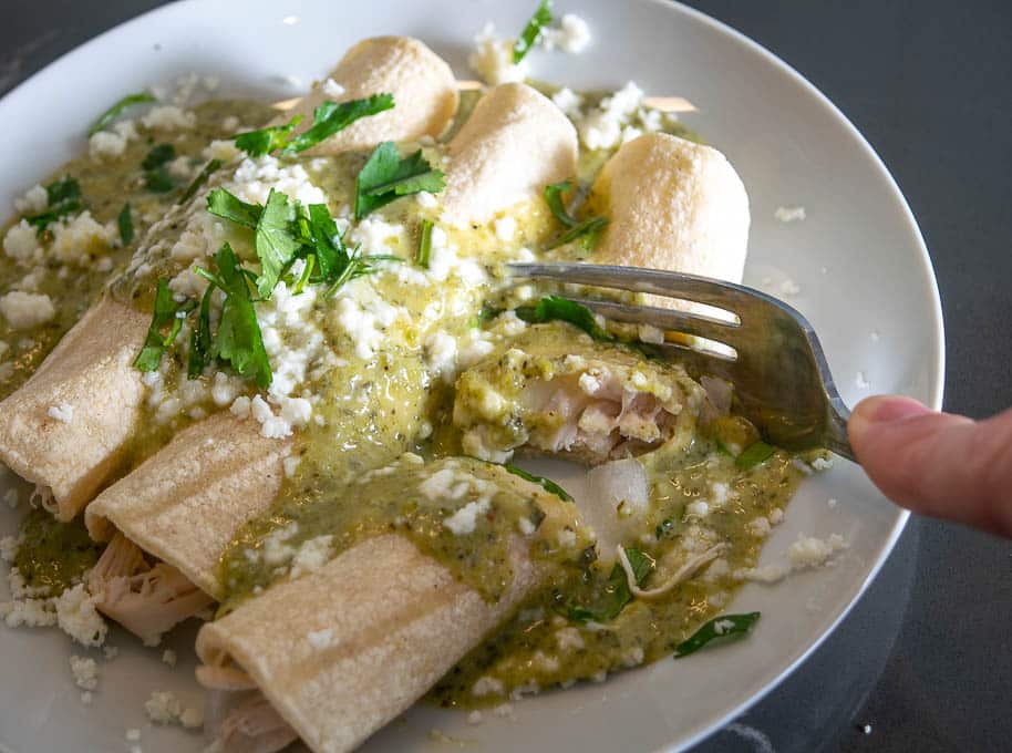 Taking a bite of the Creamy Poblano Enchiladas