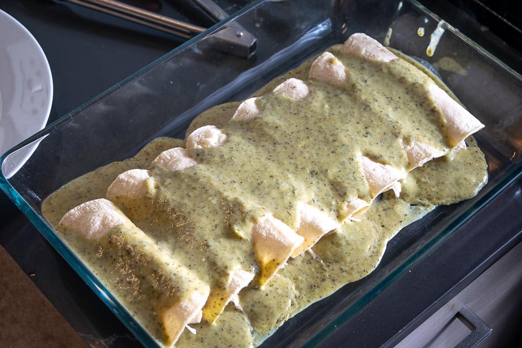 Coating the enchiladas with the Poblano sauce before baking