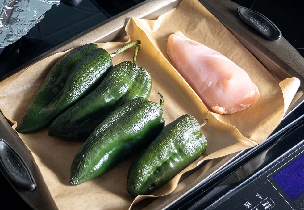 Adding the chicken to the Poblanos in the oven