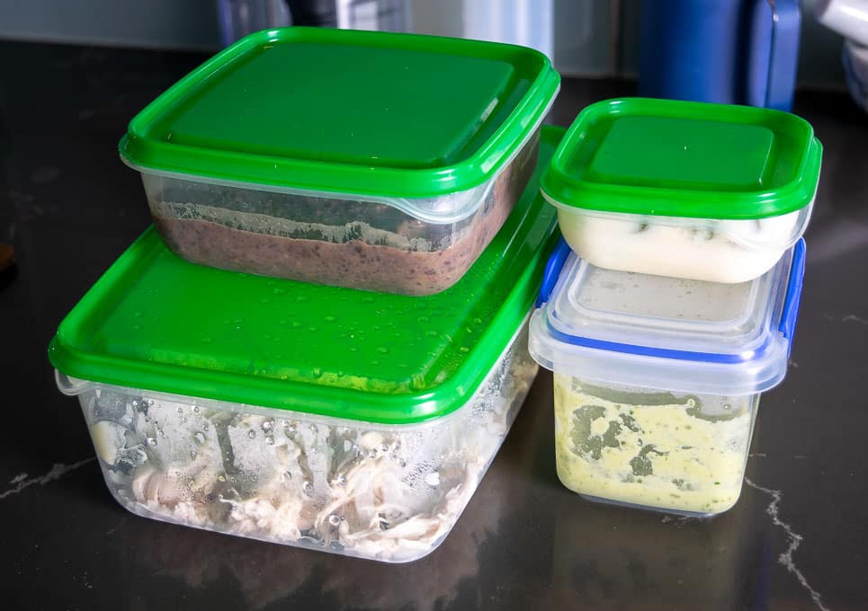 Tupperware containers with all the ingredients for Fridge Enchiladas
