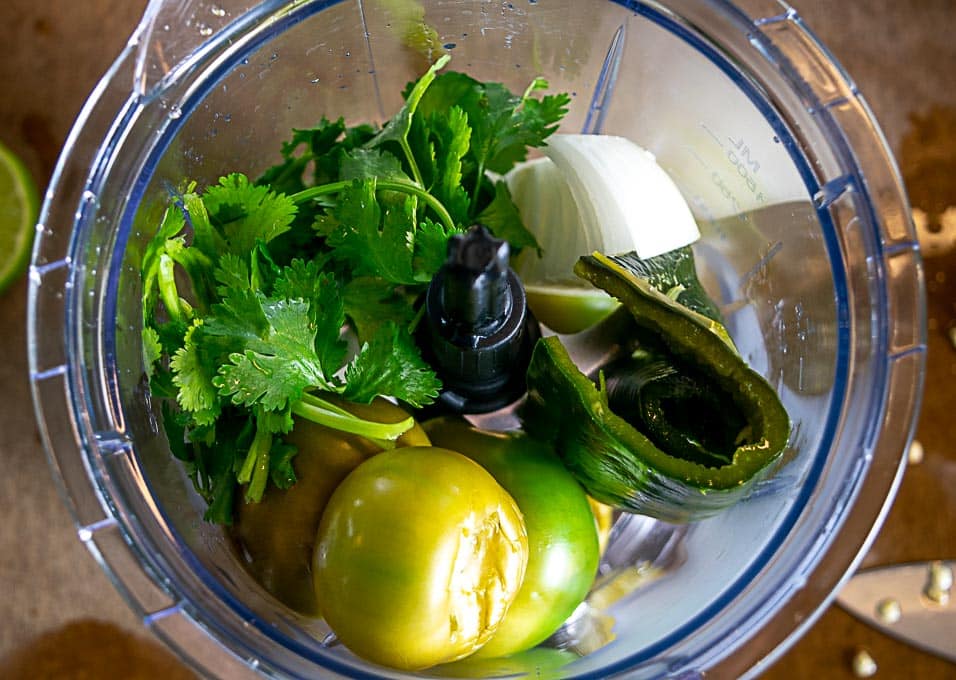 Adding the ingredients to the blender for the Pozole Verde broth
