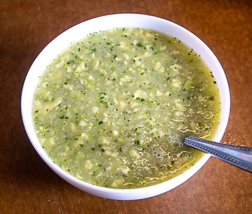 Serving Avocado Soup in a bowl with just a squeeze of lime